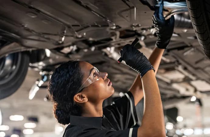 Mercedes-Benz technician working under vehicle
