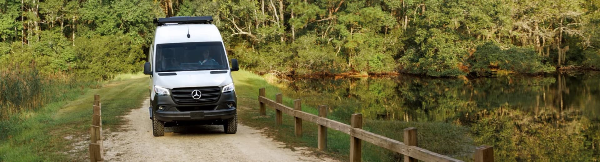 Mercedes-Benz Sprinter van driving on a lakeside road